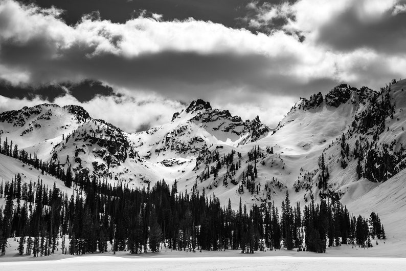 Alice Lake in Winter, Sawtooth Mountains, Idaho. Alice Lake frozen in its winter slumber with storm clouds approaching, from a winter camping trip. Black and white.