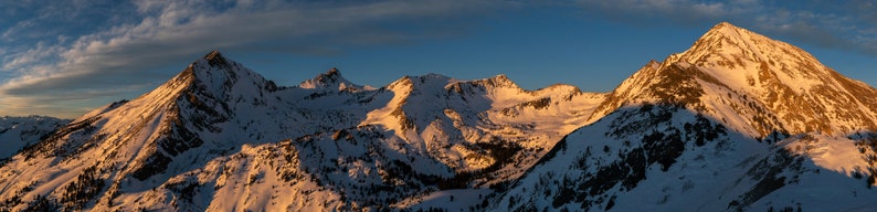 Big Basin Winter Sunset, Pioneer Mountains, Idaho. A midwinter sunset panorama of Big Basin, east of Sun Valley, where wind leaves snow clinging to the gullies below Cobb Peak.