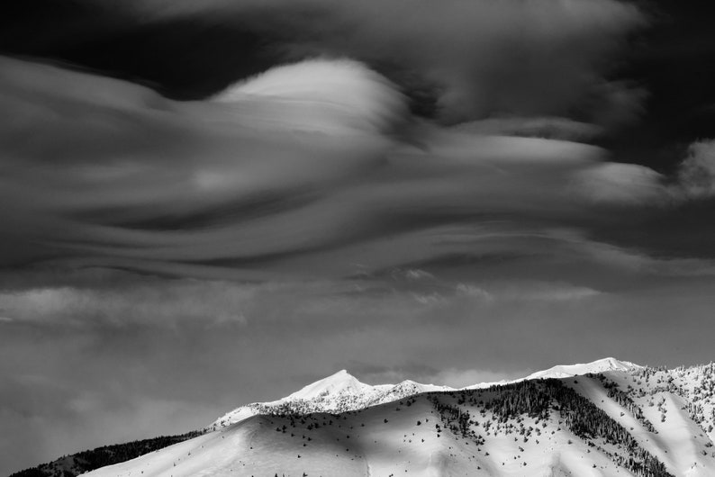 Lenticular Clouds, Boulder Mountains, Idaho. Moody lenticular clouds form over the snow-covered Boulder Mountains.
