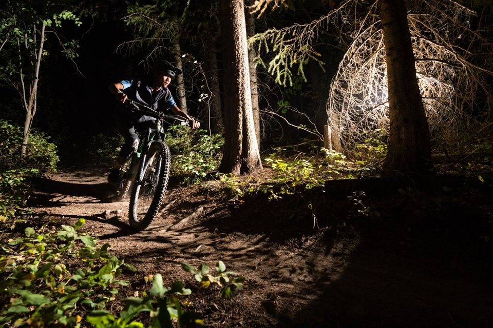 Night Riding, Driggs, Idaho. An off-camera strobe lights a rider descending Mill Creek trail outside Driggs.
