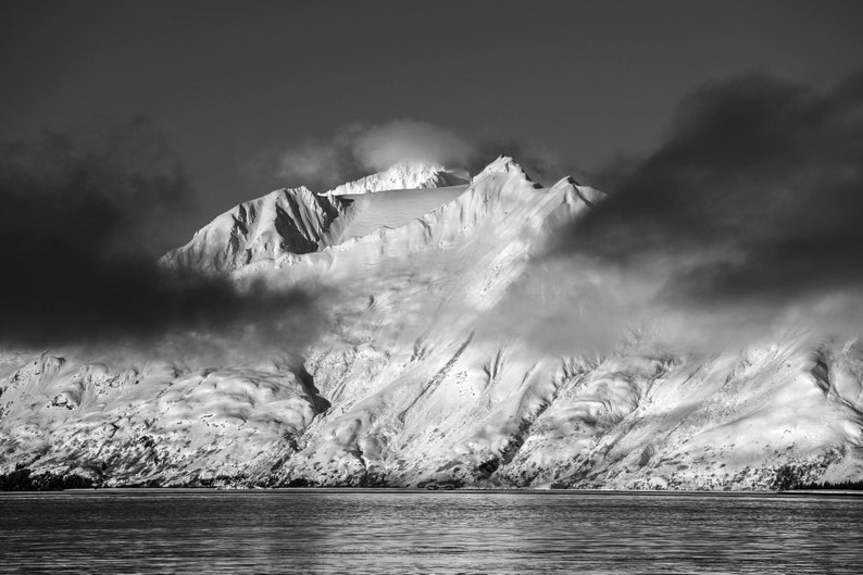 Ocean Peaks after the Storm, Aialik Bay, Alaska. Clouds part and morning light hits the peaks above Aialik Bay in April. Kenai Fjords National Park. Black and white.