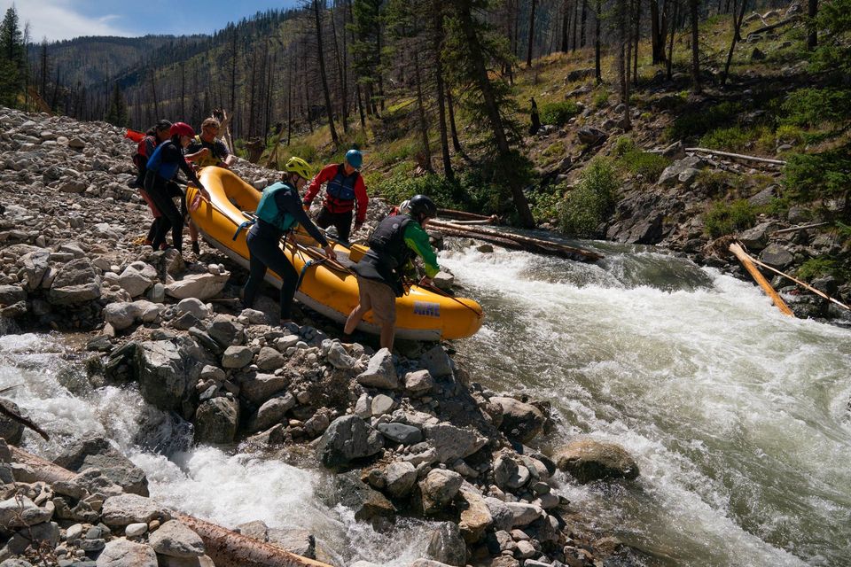 Portaging Velvet Falls. On the first Middle Fork run after the historic blowouts, the crew portages log-jammed Velvet Falls.