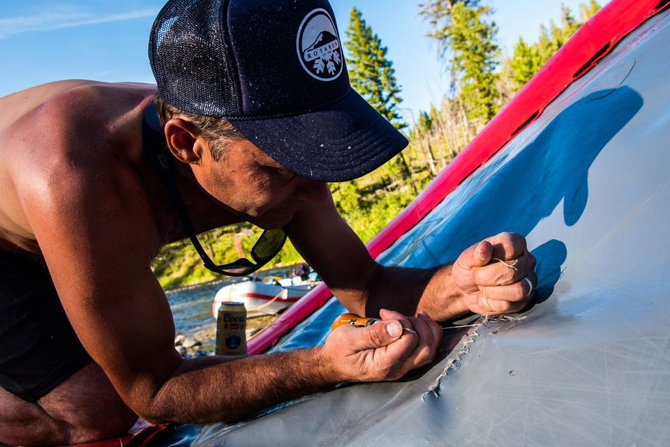 Raft Surgery. With a gash that bad, it's time for needle and thread. A repair during a low-water Middle Fork run.