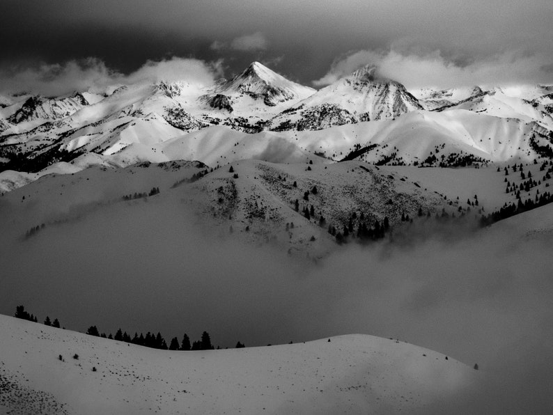 Snow-Covered Pioneer Mountains, Idaho. A storm passes over the high Pioneers as Cobb and Hyndman Peaks show through the clouds. Black and white.